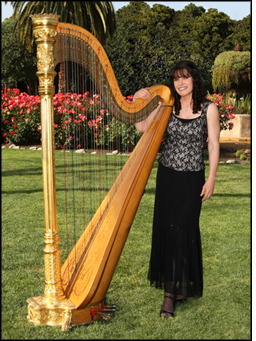 Photograph of Pamela Brown with her harp in a garden.